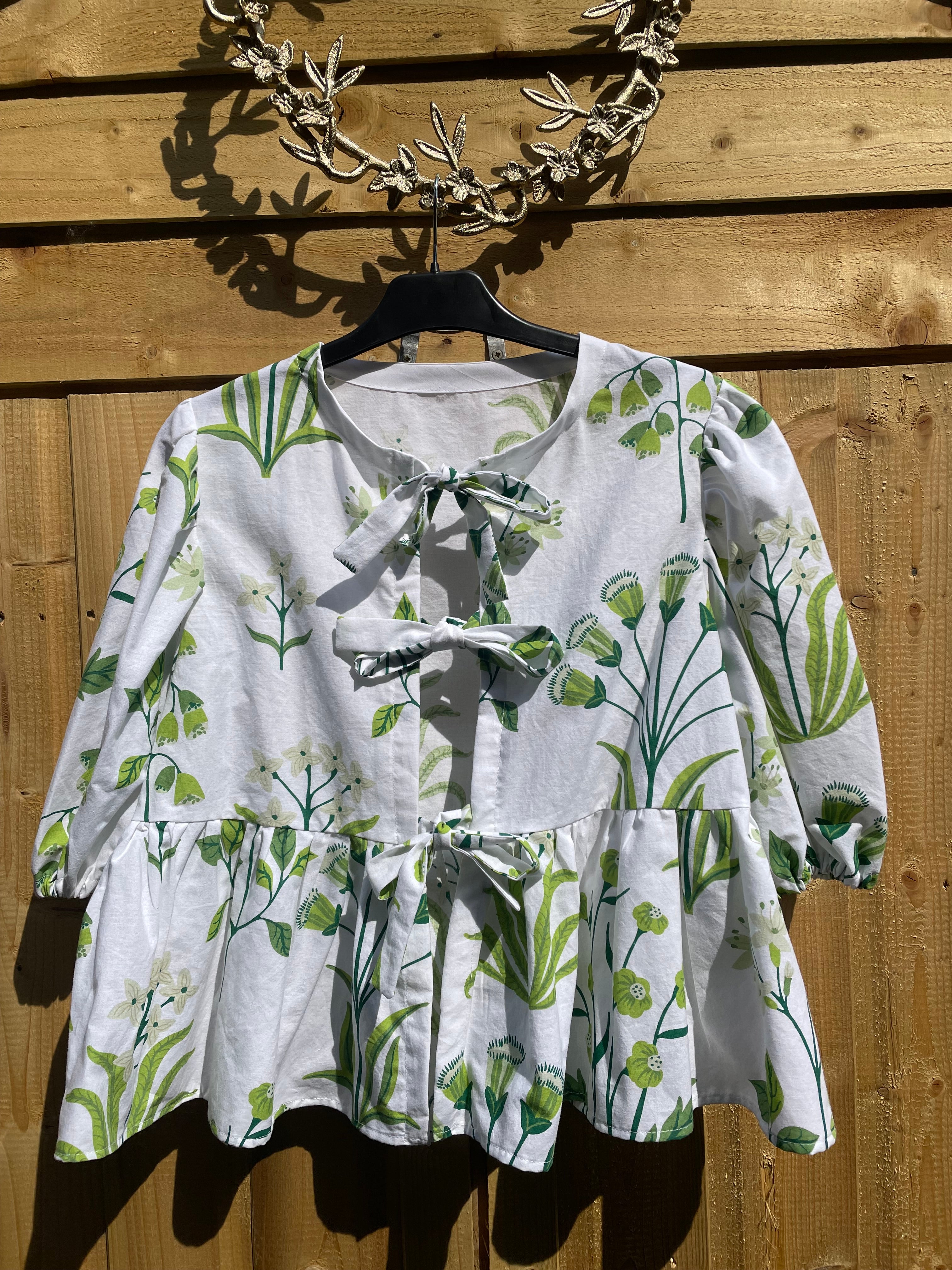 Lovely handmade Ava tie front blouse with a peplum.  White cotton with green flowers.  Size 14