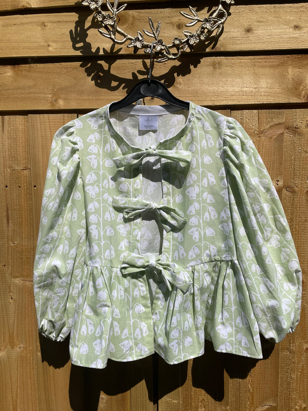 Handmade Ava blouse in pale green and white floral cotton with a peplum and tie front size 10
